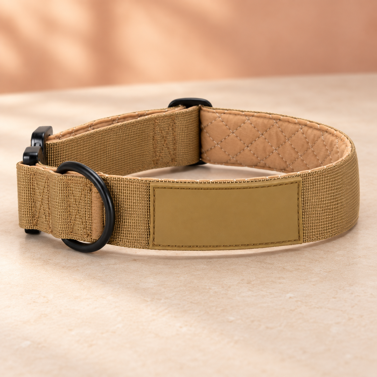 Sand Pawblefy tactical collar showing woven nylon, quilted padding and dark hardware with a blank personalization panel